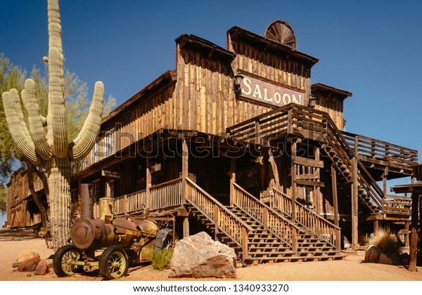 Old Wild \
Western Wooden Saloon in Goldfield Gold Mine Ghost Town in\
Youngsberg, Arizona, USA surrounded by\
cactuses