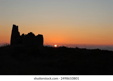 Old windmill, sunset, mountain, scenic view, historical windmill, twilight, rural landscape, windmill silhouette, evening sky, picturesque, golden hour, countryside, heritage site, traditional windmil - Powered by Shutterstock