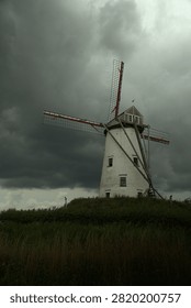 Old windmill under a cloudy sky in the Belgian town of Damme.