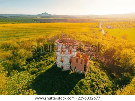 Old windmill Windsor. Sunset or sunrise photo of tower ruins of the mill Windsor in Ceske stredohori region in Czech republic