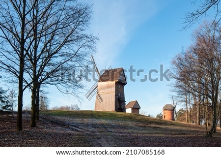 Old windmills. Wooden and masonry buildings. Traditional old polish countryside wooden houses and farmyards. Open-air ethnographic museum in Dziekanowice, Poland.
