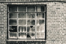 Old Window With Broken Panes That Has Been Boarded Up. Set N Brick Wall In Warm Tone Black And White.