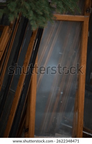old window frames stacked up like books on a shelf. 