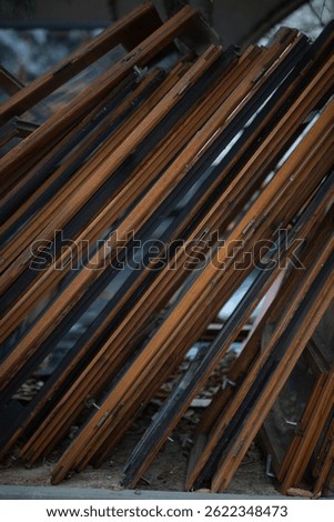 old window frames stacked up like books on a shelf. 
