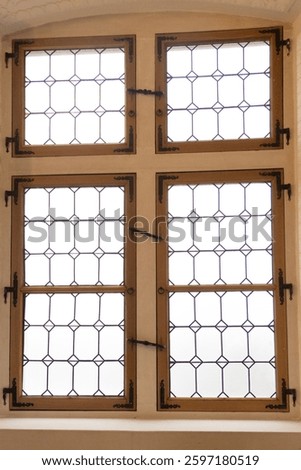 old window in medieval castle close up. Stained glass of old window during daytime