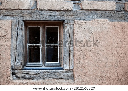 Old window on the facade of a half-timbered house