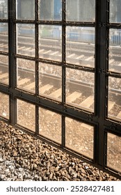 old window in a train station with a view at the tracks