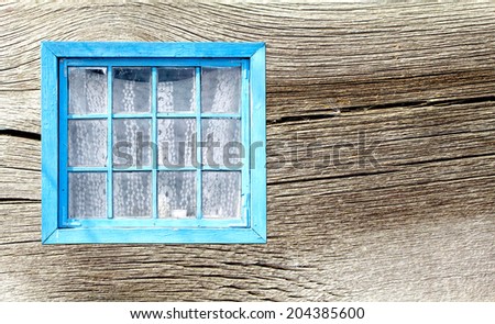 Old window of a wooden house wall