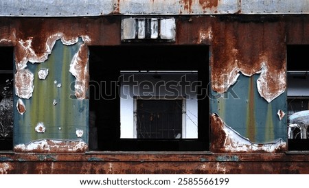 An old, windowless train car covered in rust, abandoned and weathered by time. The metal surface is corroded, with peeling paint and signs of decay, evoking a sense of history and forgotten journeys.
