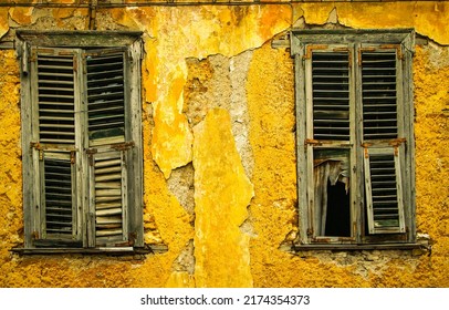 Old windows of an abandoned house. Windows with shutters oa abandoned house. Old window shutters. Closed windows with shutters in abandoned house - Shutterstock ID 2174354373