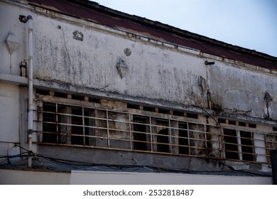 Old windows with iron bars on dull walls - Powered by Shutterstock