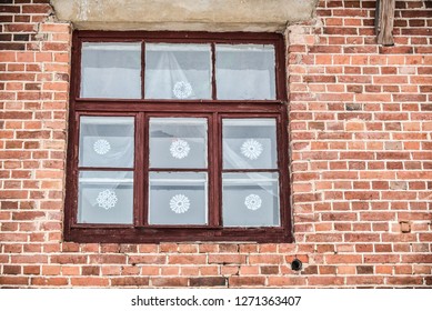 Old Windows On The Brick House. Paper Snowflakes On The Window Glass