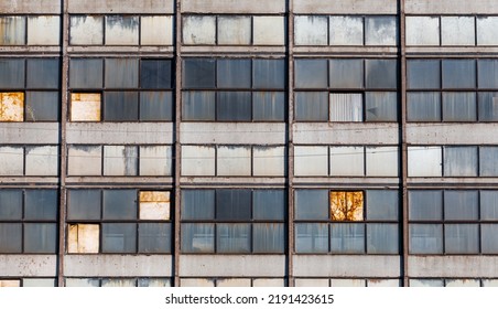 Old windows in Soviet  era industrial building and close  up view from the front  Windows an abandoned industrial building  Windows building
