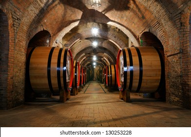 Old wine barrels in the vault of winery