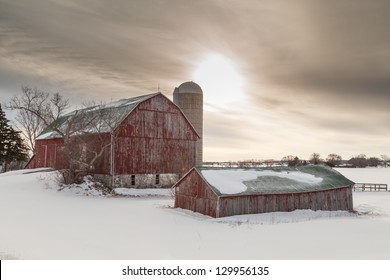 Old Winter Barn On Snow Covered Farm Field In Northern Ontario.