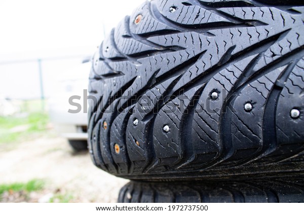 Old winter car tire.\
Studded rubber close-up. Additional spikes in the tire. Winter car\
tire repair.