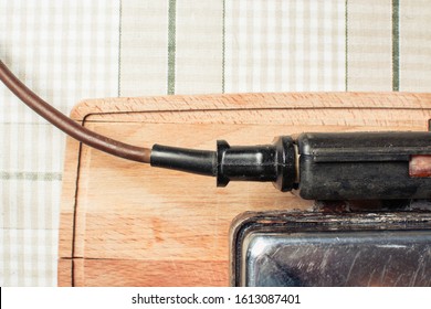 Old Wire Stuck In Waffle Iron On Kitchen Table