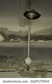 

old wiring on the ceiling with a socket for a light bulb