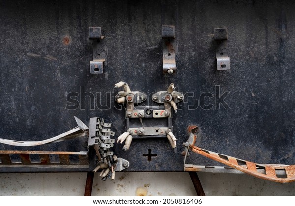 Old wiring\
panel with cut wires and rusted\
parts
