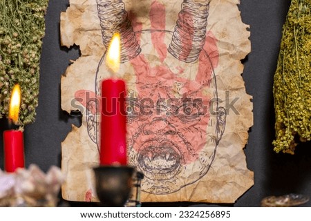 Old witch book Ancient parchment paper page with image of devil head. Portrait of demon with horns or antlers and sharp fangs on witchcraft magic book page. Satan or Lucifer fallen angel.