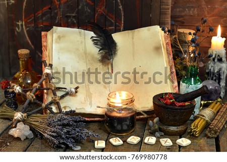 Old witch book with empty pages, lavender flowers, pentagram and witchcraft objects. Occult, esoteric, divination and wicca concept. Mystic and vintage background 