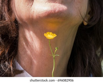 Old Wive's Tale Test Of Whether You Like Butter By Placing A Buttercup Under Your Chin To See If There Is A Yellow Reflection On Your Skin