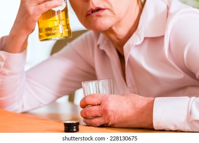 Old Woman With Alcohol Problem Sitting At Home Drinking Hard Liquor 