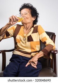 Old Woman Asian With Beer Or Wine, She Drink Like This Every Day. (90 Years Old)