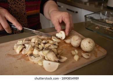 Old woman cutting mushrooms at cooking classes, close up.
 - Powered by Shutterstock