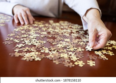 Old Woman Doing A Jigsaw Puzzle