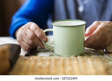 Old Woman Is Drinking Tea In Her Country Style Kitchen