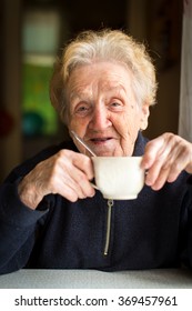 Old Woman Drinking Tea, Portrait Close-up.