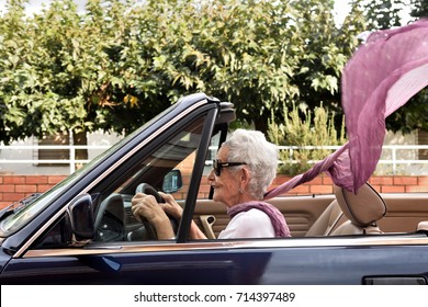 Old Woman Driving A Convertible Car