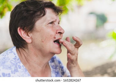 Old Woman Eating Chocolate - Senior Preparing Biting Or Putting A Piece Of Sweet Snack Into Her Open Mouth