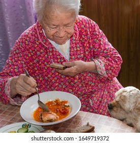 Old Woman Eating Soup At Home