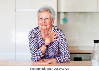 Old Woman With Emergency Alarm Button At Home. Medical Care Concept
