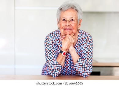 Old Woman With Emergency Alarm Button At Home. Medical Care Concept
