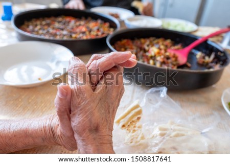 Old woman enjoying some homemade okra