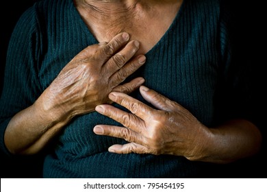 Old Woman Felt Heart Ache On Black Background,Illness Of The Elderly Problem Concept