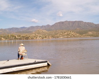 Old Woman Fishing At The Lake