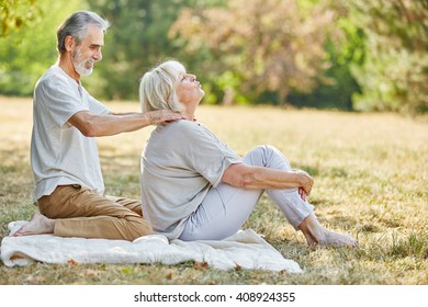 Old Woman Gets A Neck Massage From Her Husband In Summer 