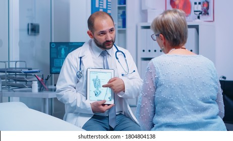 Old woman getting medical advice about osteoporosis bones disease from experienced doctor in private clinic sitting on hospital bed. Patient healthcare treatment and health consultation - Powered by Shutterstock