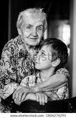 Similar – Grandma cuddles up with her grandson