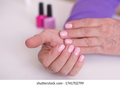 Old Woman Hands With Manicure And Pink Gel Polish On Nails 