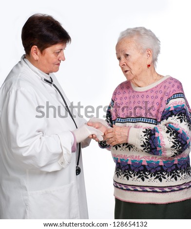 Old woman having discussion with her doctor on a white background