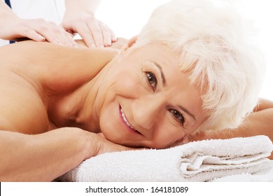 An Old Woman Is Having A Massage. Spa Concept.  Over White. 