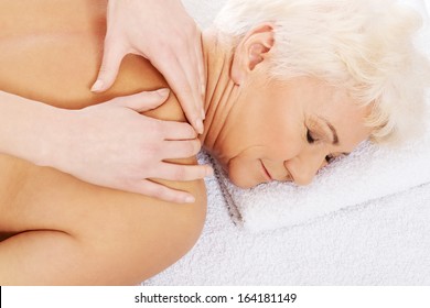 An Old Woman Is Having A Massage. Spa Concept.  Over White. 