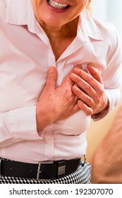 Old woman holding breast because of heart infarction 