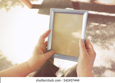 Old Woman Holding Photo Frame. Memories Concept