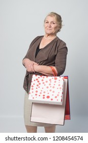 an old woman holding shopping bags